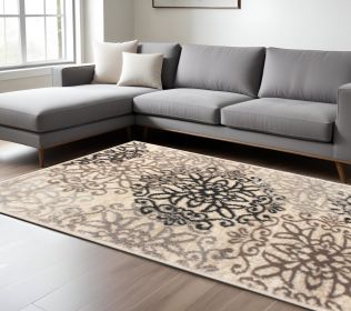 7' X 9' Tan Gray And Black Floral Medallion Stain Resistant Area Rug