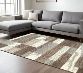 7' X 9' Light Blue And Ivory Patchwork Power Loom Stain Resistant Area Rug